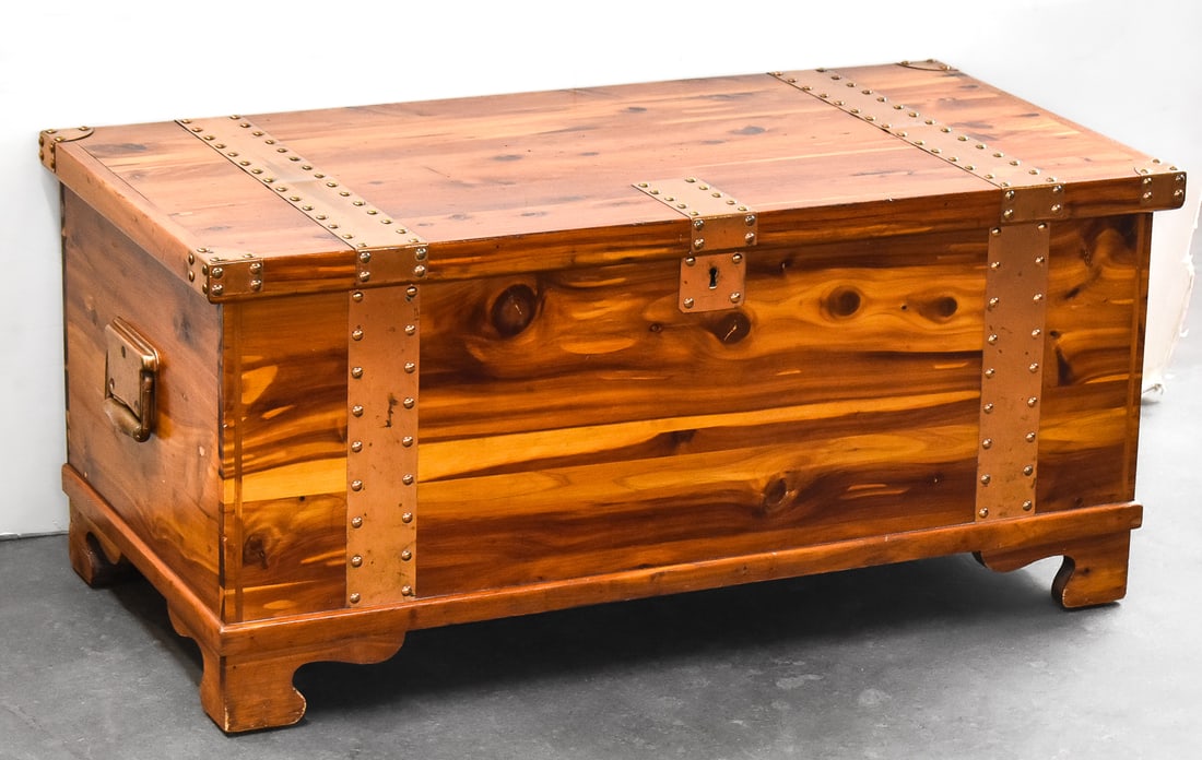 J.W. HIGGINS - PORTLAND CEDAR & COPPER CHEST: A J.W. Higgins - Portland cedar chest with copper bracing, circa mid 20th century. The largest item measures 17" H, 36.5" W, 19" D.