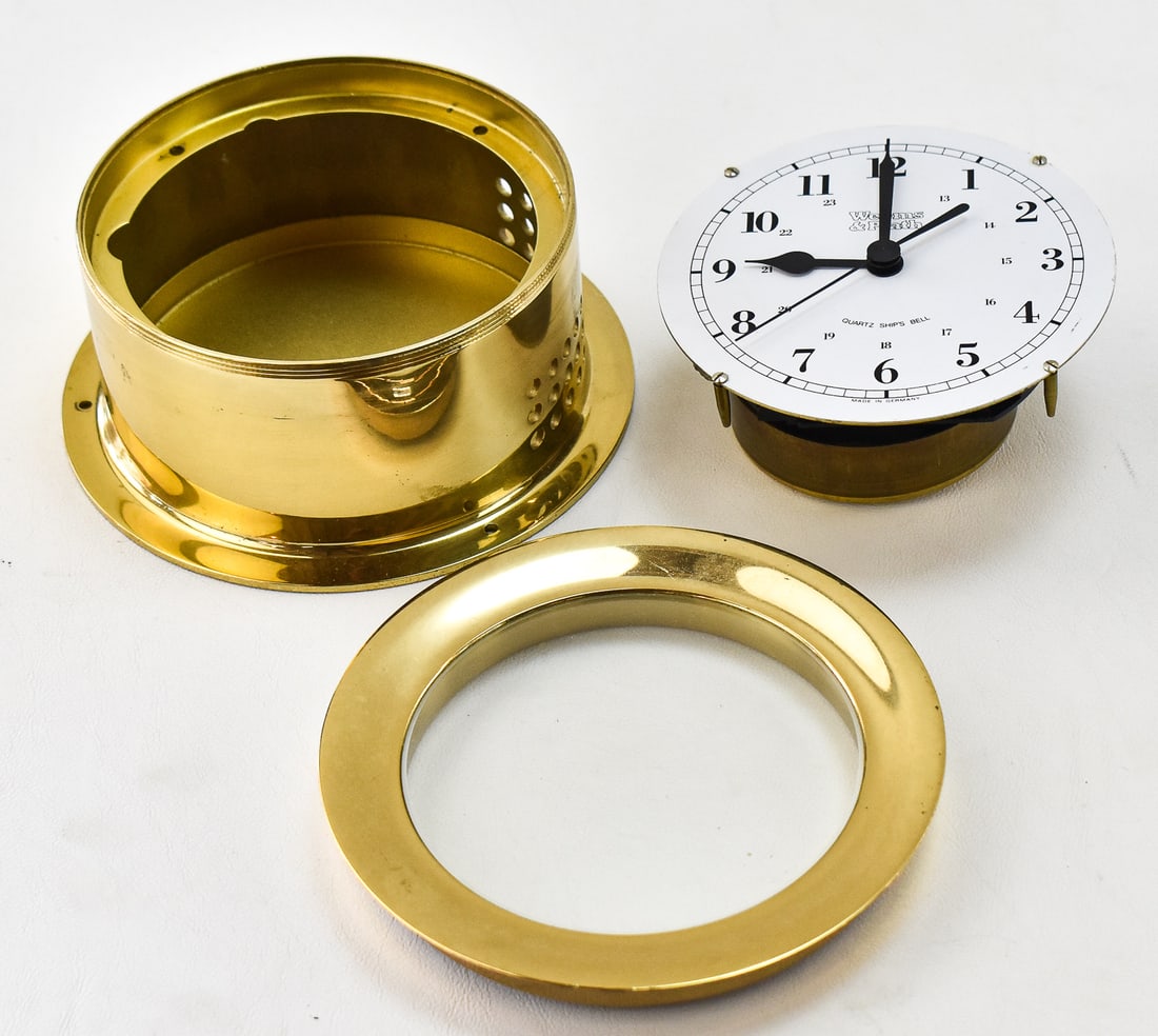 WEEMS & PLATH GERMAN NAUTICAL CLOCK: A vintage battery operated Weems & Plath German nautical clock with brass casing. The photos show the clock disassembled however it will come fully assembled. Measures 5.25" H x 5.25" W x 3" D.