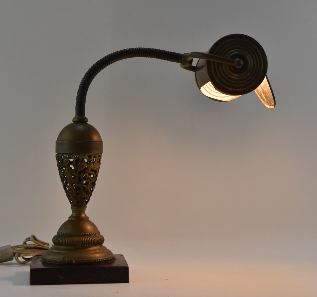 THE ALMOND MANUFACTURING COMPANY BRASS TABLE LAMP: The Almond Manufacturing Company brass table lamp with a pierced design to the base, dated 1890. The item measures 13.5" H, 10.5" W, 15.5" D.