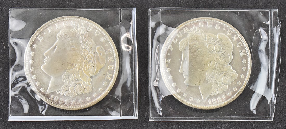 PAIR OF 1921 MORGAN DOLLARS: A pair of 1921 Morgan dollars minted in Philadelphia. Each coin is struck in 90% silver with an approximate weight of 26.7 grams.