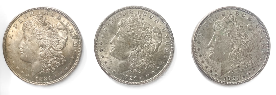 THREE 1921 MORGAN SILVER DOLLARS: Three 1921 U.S. Morgan silver dollars minted in Philadelphia. Each silver dollar is struck in 90% silver with each having a weight of approximately 26.7 grams.