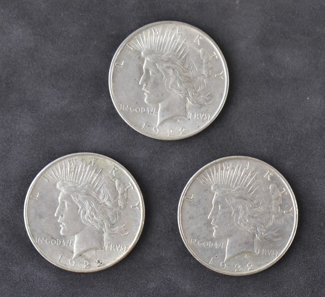 3 1922 PEACE DOLLARS: Three 1922 Peace Dollars minted in Philadelphia. Each coin is struck in 90% silver and has an approximate weight of 26.7 grams.