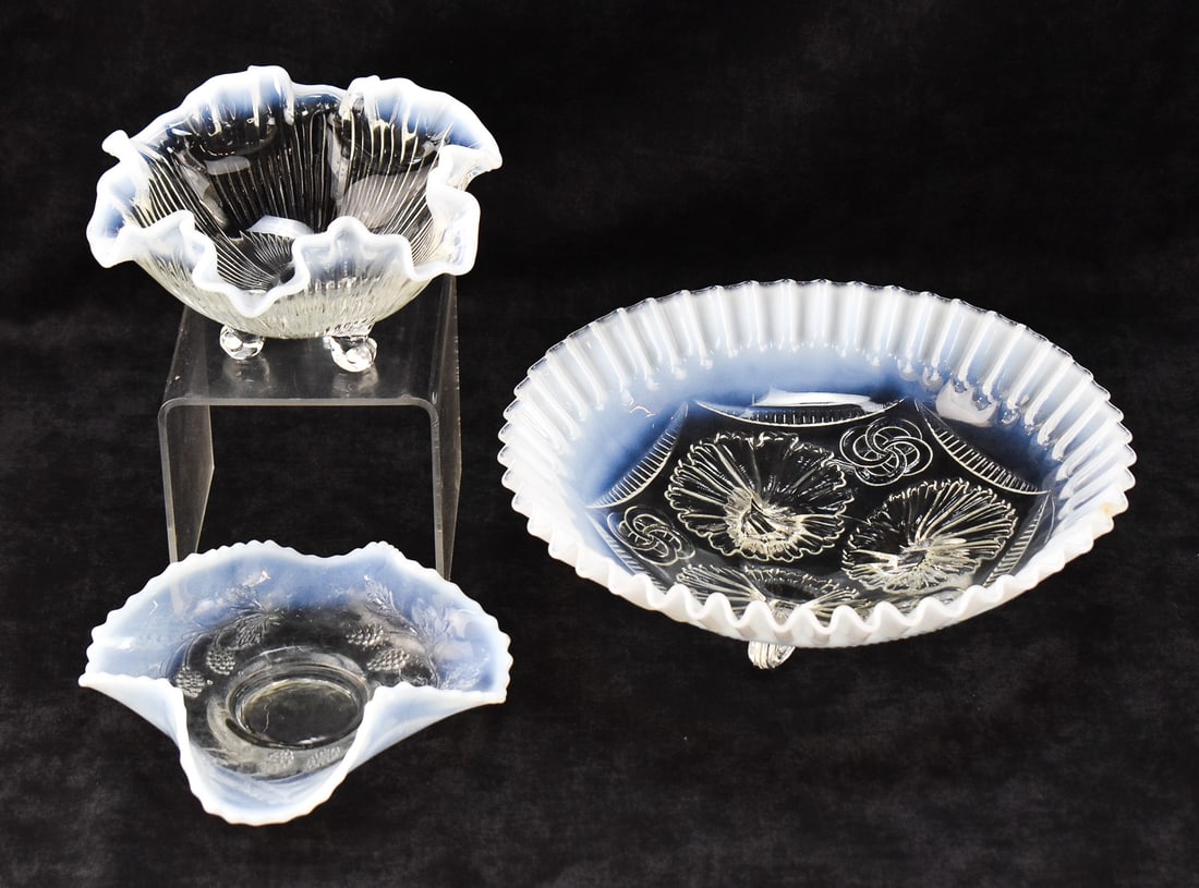 ASSORTMENT OF OPALESCENT GLASSWARE: An assortment of opalescent glassware including a Fenton made for Tiara "Tea Rose" pattern three-toed bowl, a Jefferson Glass "Ruffles and Rings" opalescent bowl, and a crimped ruffled rim opal colore