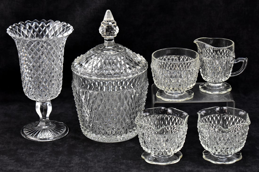 COLLECTION OF DIAMOND PATTERN GLASS & CRYSTAL: A collection of clear glass and crystal including a glass footed celery vase with a British registry mark dating the piece December 21, 1868, and a set of Diamond Point patter crystalware by Indiana G
