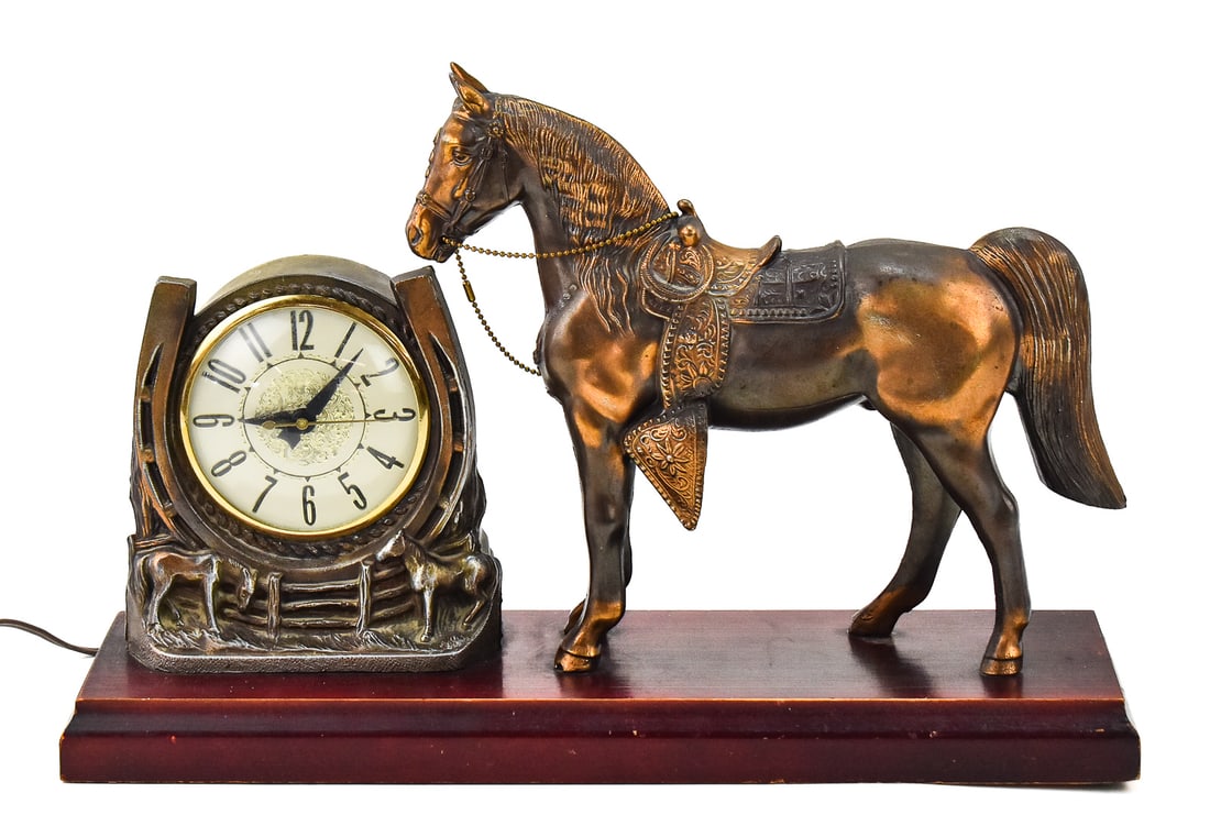 ST. JUDE CHARITY LOT: SPARTUS CAST METAL HORSE AND MANTLE CLOCK: A Spartus cast metal horse and electric horseshoe-design mantle clock, produced in 1952. The item measures 11" H x 17" W x 5" D. Proceeds from this lot benefit the St Jude Children's Research