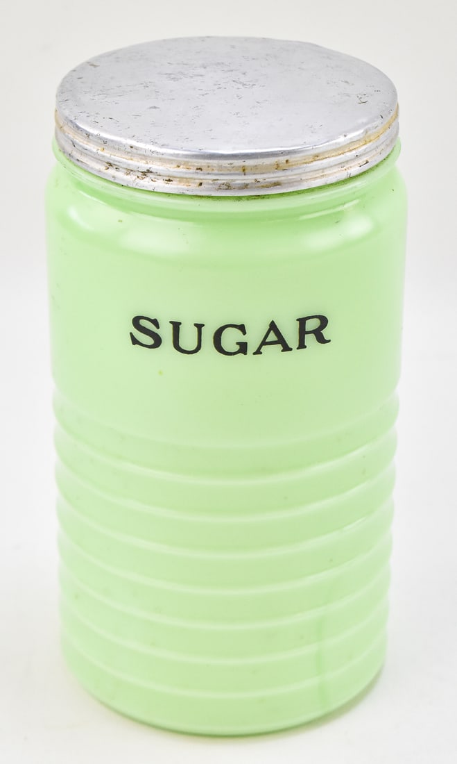 JADEITE SUGAR CANISTER, JEANNETTE GLASS COMPANY: A Jadeite glass sugar canister produced by the Jeannette Glass Company, circa 1930s-1950s. The canister measures 7.75" H x 4" W x 4" D.