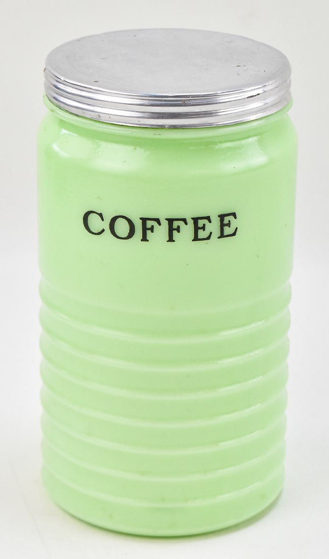 JADEITE COFFEE CANISTER, JEANNETTE GLASS COMPANY: A Jadeite glass coffee canister produced by the Jeannette Glass Company, circa 1930s-1950s. The canister measures 7.75" H x 4" W x 4" D.