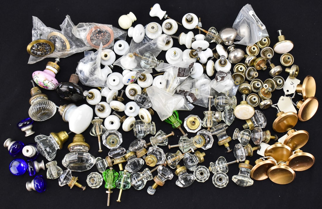 ASSORTMENT OF DOOR AND DRAWER KNOBS; CIRCA EARLY-LATE 20TH CENTURY: This lot includes an assortment of door and drawer knobs in various compositions (brass, glass, porcelain), circa early-late 20th century. The largest item measures 2" H, 2.5" W, 3" D.