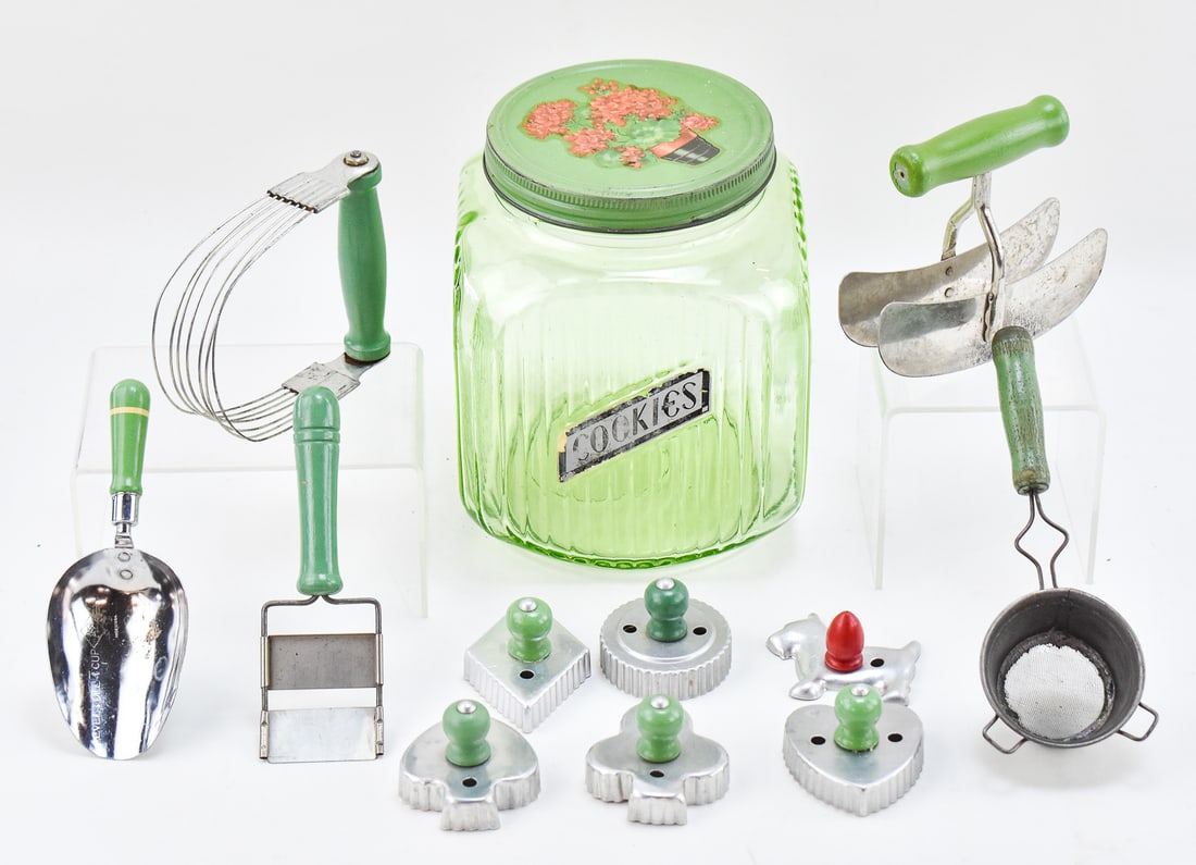 HOOSIER 'COOKIES' URANIUM GLASS RIBBED CANISTER & EARLY 20TH CENTURY PASTRY TOOLS: This lot includes the following, circa early 20th century: Hoosier "Cookies" uranium glass ribbed canister, tea strainer, A & J measuring scoop, food chopper, wire pastry blender, cheese slicer,