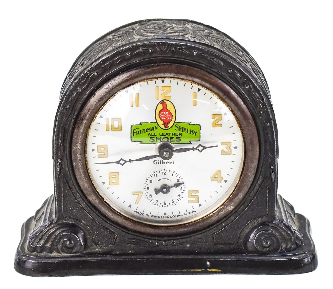 GILBERT ART DECO ADVERTISING CLOCK FOR RED GOOSE SHOES: A Gilbert Art Deco cast metal mantel clock advertising Friedman Shelby - Red Goose Shoes, circa early 20th century. The item measures 5" H, 6" W, 2.5" D.