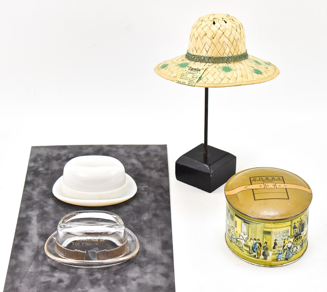 MINIATURE DECORATIVE HAT ASSORTMENT: GLASS FEDORA SOUVENIRS, ZARNLAC SALESMAN SAMPLE, & MORE: This lot includes a Zarnlac woven ladies sun hat salesman sample with a hat stand, "Souvenir of Toledo, Ohio" glass fedora circa mid 20th century, milk glass fedora hat, and a Dobbs Fifth Avenue powde