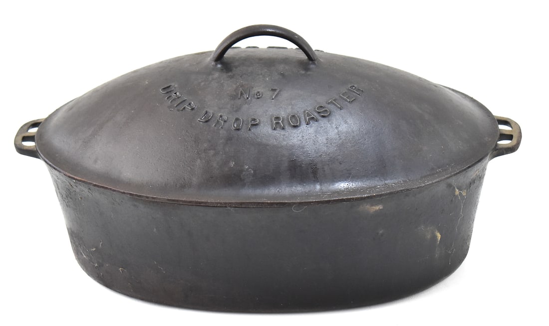 WAGNER WARE CAST IRON DRIP DROP ROASTER NO. 7: A Wagner Ware cast iron lidded oval drip-drop roaster No. 7, circa early 20th century. The item measures 9.5" H, 17.5" W, 11.5" D.