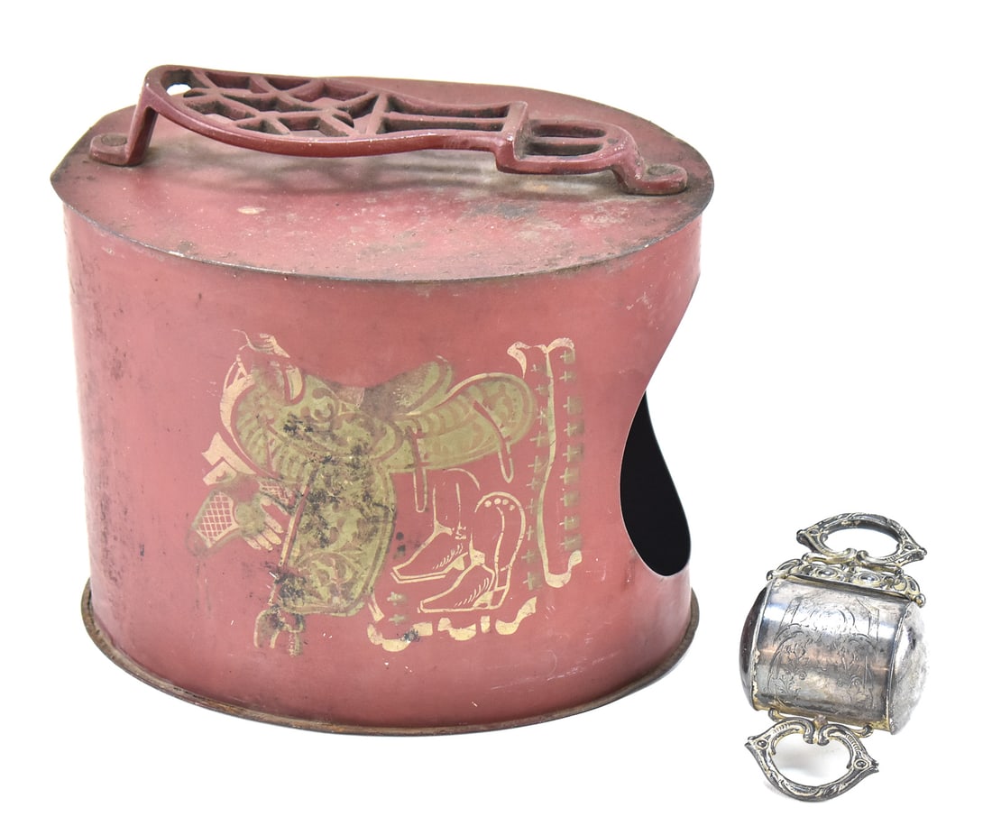 WESTERN-THEMED TOLEWARE SHOE SHINE BOX AND SILVERPLATE RETRACTING RAZOR STROP: This lot includes a Western-themed toleware shoe shine box circa early 20th century and a silverplate engraved retracting razor strop circa late 19th century. The largest item measures 9.5" H, 10" W,