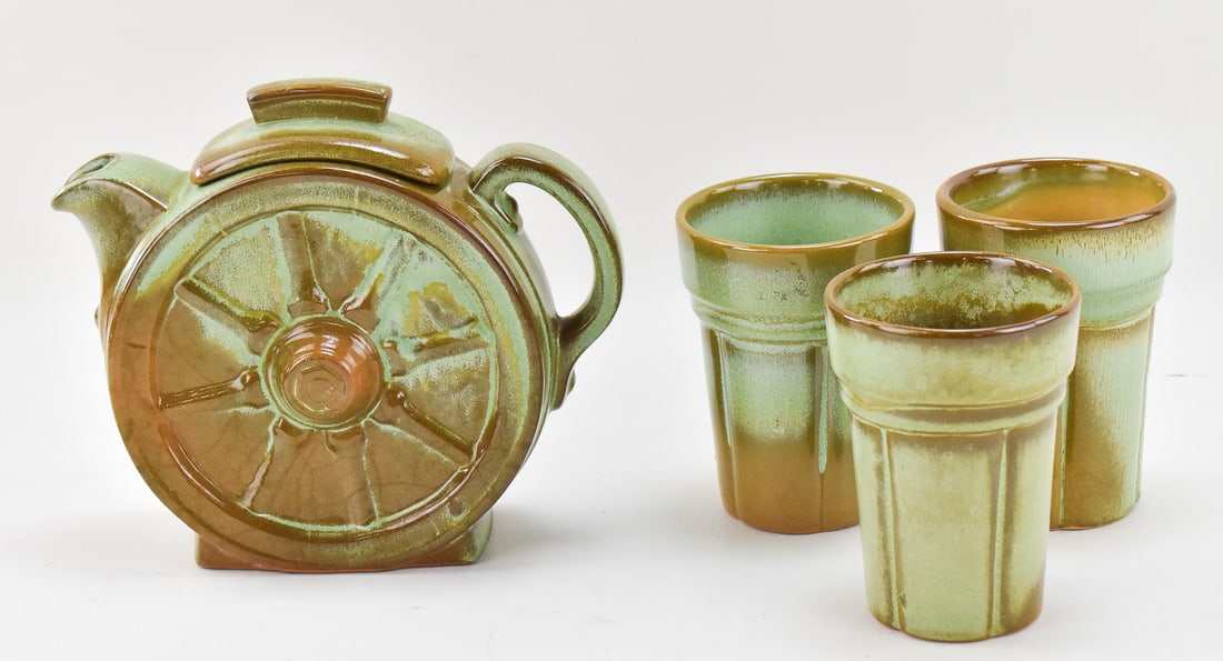 FRANKOMA POTTERY 'WAGON WHEELS' TEAPOT & CUPS: A Frankoma Pottery "Wagon Wheels" pattern No. 94T teapot and three cups, circa 1948-1988. The largest item measures 7" H, 8" W, 3.5" D.