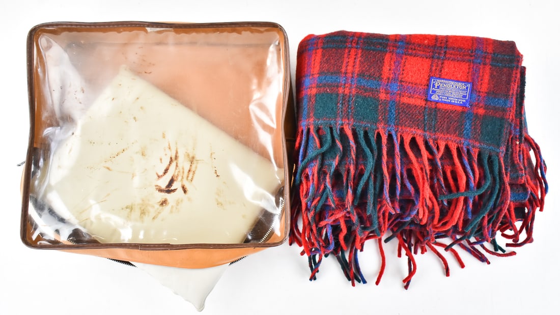 PENDLETON WOOLEN MILLS TARTAN FRINGE ROBE STADIUM BLANKET: A Pendleton Woolen Mills tartan fringe robe stadium blanket with carry bag and cushion, circa late 20th century. The item measures 4.5" H, 14" W, 12" D.