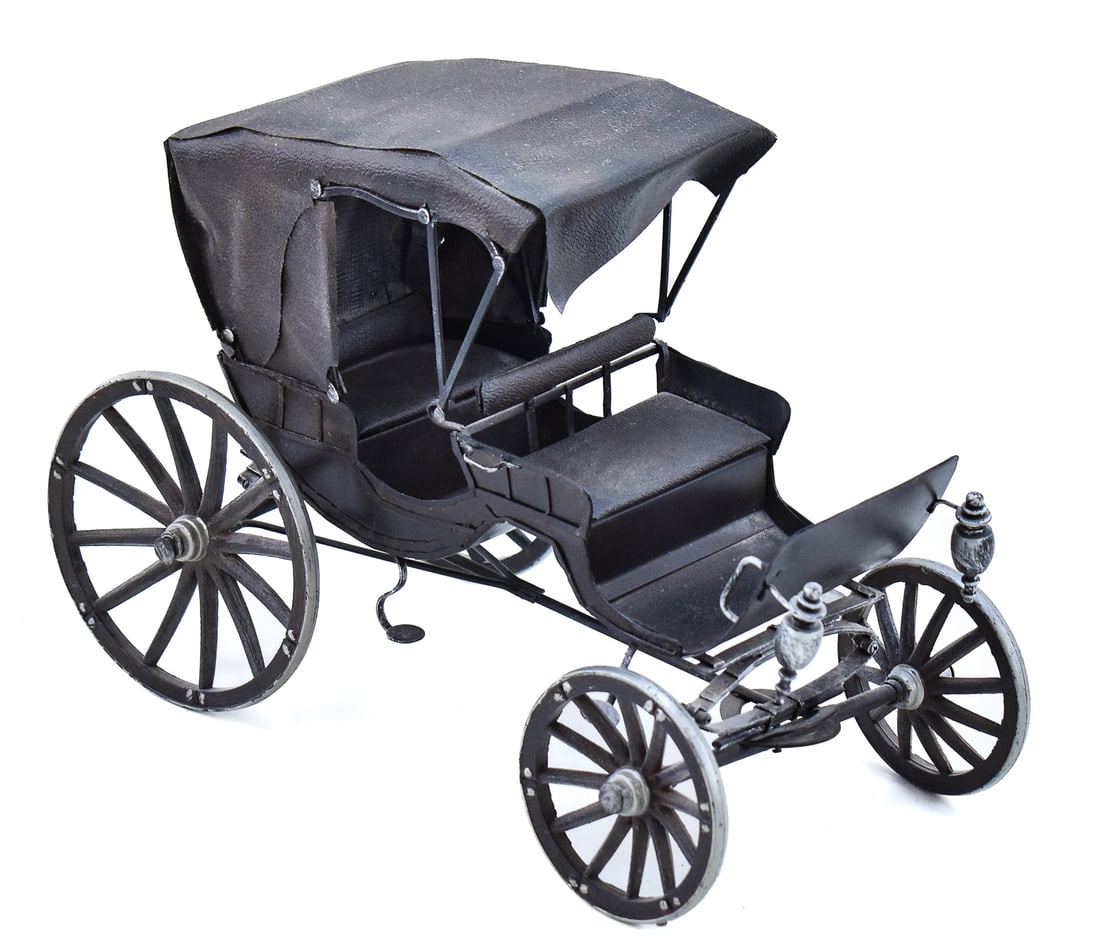 CONTEMPORARY MODEL HORSE-DRAWN BUGGY CARRIAGE: A contemporary metal and faux leather model horse-drawn buggy carriage. The item measures 9.5" H, 13" W, 7" D.