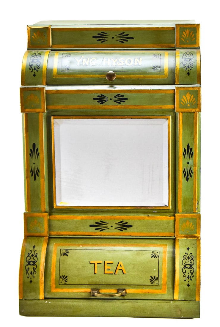 YOUNG HYSON PAINTED TIN GENERAL STORE COUNTER-TOP TEA DISPENSER: A Young Hyson painted tin general store counter-top tea dispenser with a mirror-front, circa late 19th century. The item measures 30" H, 19" W, 18" D.