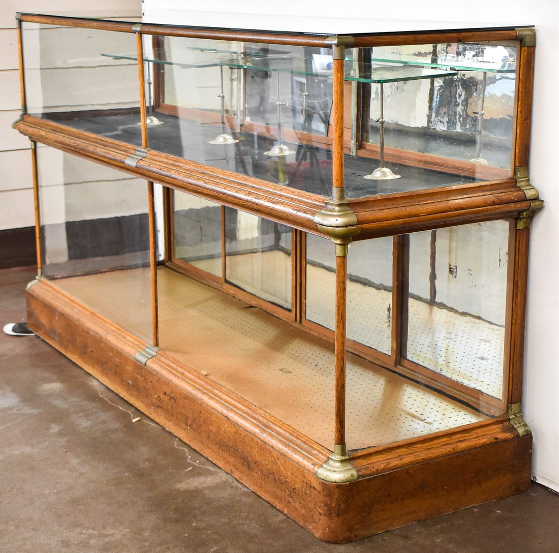 ANTIQUE DIXON BORGESON TWO-PIECE OAK & GLASS GENERAL STORE DISPLAY SHOWCASE: A antique circa late-1800s to early-1900s large two-piece oak and glass general store display showcase manufactured by Dixon Borgeson & Co. out of Portland, Oregon. The cabinet measures 46" H x