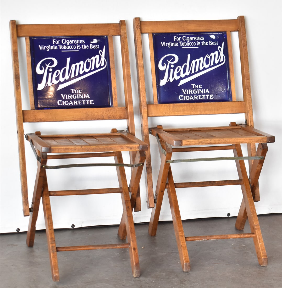 TWO SIMMONS COMPANY PIEDMONT CIGARETTES ADVERTISING CHAIRS: This lot includes two Simmons Company Piedmont "The Virginia Cigarette" advertising folding chairs with double-sided porcelain enamel backs, circa early 20th century. The item measures 30.5" H, 16.5"