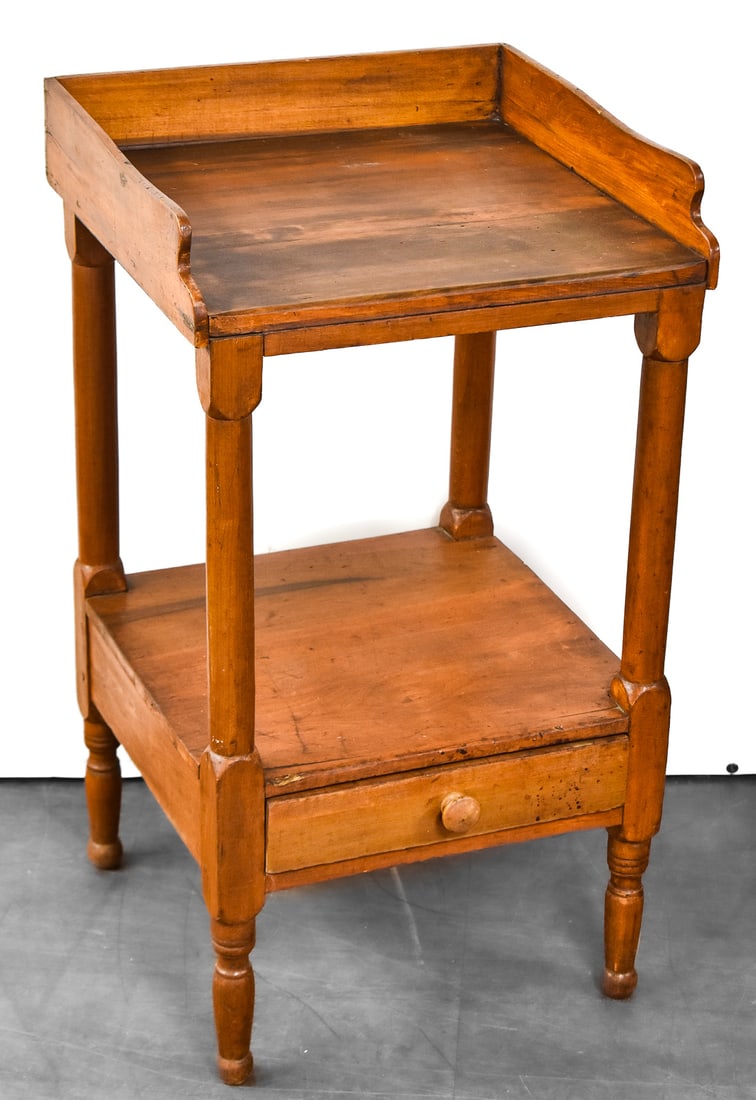 WASHSTAND WITH BACKSPLASH: Washstand is made of oak with a single drawer on the bottom shelf. Drawer has single dovetail joint construction. Washstand measures 33.5" H x 19" W x 18" D.