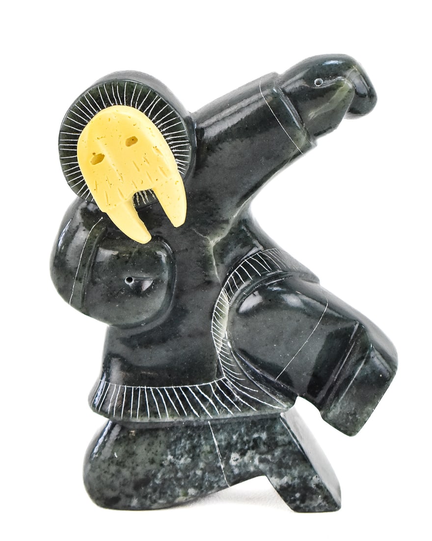 VIKSON SIGNED CARVED SOAPSTONE INUIT MAN WALRUS TRANSFIGURATION: A Vikson signed carved soapstone Inuit man transfiguration with a resin walrus mask. The item standing measures 5.5" H, 4" W, 1.5" D.