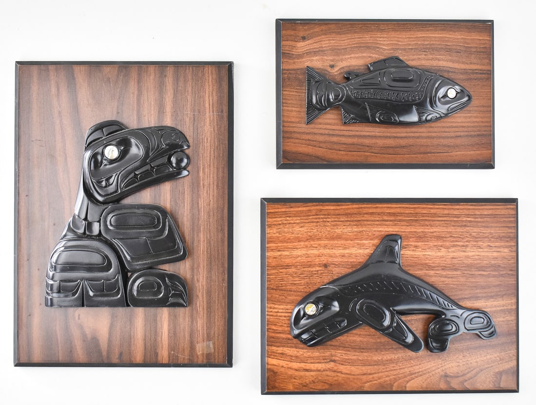 THREE CONTEMPORARY CANADIAN NORTHWEST COAST TRIBAL STYLE PEARLITE WALL PLAQUE SOUVENIRS: This lot includes three contemporary Canadian Northwest Coast tribal style Pearlite wall plaque souvenirs. The largest item measures 1.5" H, 10" W, 14" D.