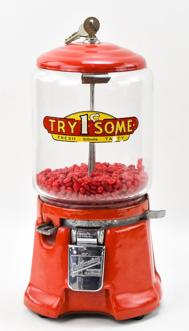 1930s NORTHWESTERN CORPORATION RED PORCELAIN GUMBALL MACHINE MODEL 33: A 1930s Northwestern Corporation gumball machine model 33 with a red porcelain cast iron body and a glass globe top. It measures 13.5" H x 7" W x 7" D. A set of keys is included.