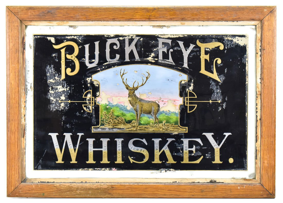 BUCKEYE WHISKEY REVERSE PAINTED SIGN, EARLY 20TH CENTURY: A Buckeye Whiskey reverse painted sign with a wooden frame, circa early 20th century, pre-prohibition era. The sign measures 24.5" H x 34.5" W x 1" D.