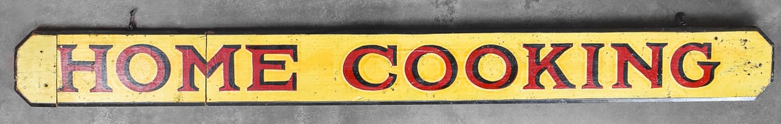 EARLY 20TH CENTURY LUNCHEONETTE 'HOME COOKING' SIGN: A hand-painted luncheonette "Home Cooking" wooden hanging sign, circa early 20th century. The item measures 7" H, 62.5" W, 1.5" D.