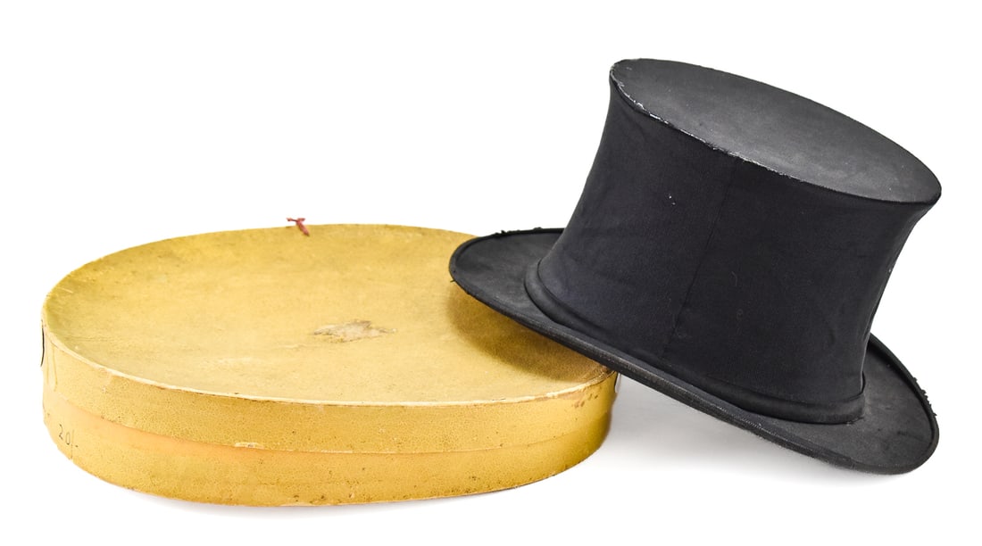 COLLAPSIBLE TOP HAT WITH BOX: Top hat was manufactured by the British company of Austin Reed, logo is still very legible inside the hat. When fully open hat measures 6" H x 10.5" W x 13.5" D. Collapsible top