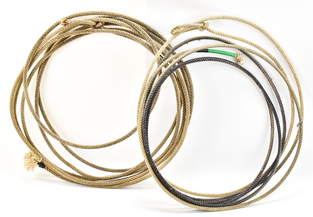 PAIR OF LARIATS: A pair of vintage western lariats or commonly known as lassos. The largest is approximately 30 ft. in length. When coiled up the largest lariat measures approximately 22" H x 22" W x 2" D.