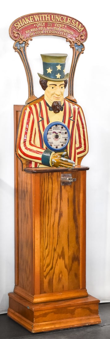 TWENTY FIVE CENT 'SHAKE HANDS WITH UNCLE SAM' GRIP TESTER: A twenty five cent "Shake Hands with Uncle Sam" grip tester in an oak case with front metal castings, circa early 1970s. The item measures 74" H, 21" W, 18" D.