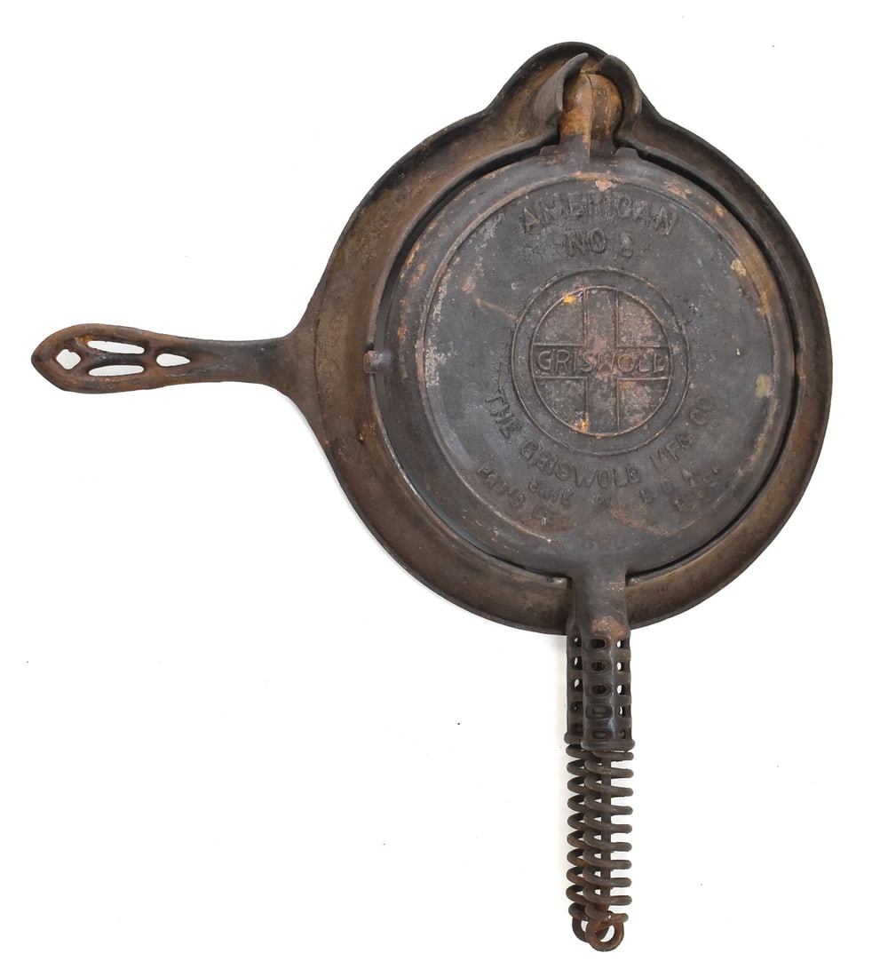 GRISWOLD #8 WAFFLE IRON: A Griswold #8 waffle iron circa 1910s with all original pieces. The waffle iron measures 2.5" H x 15" W x 17" D.