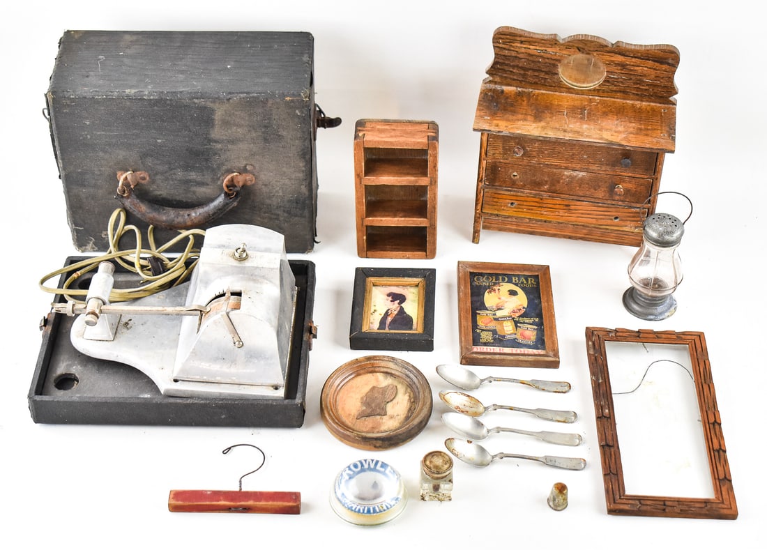 COLLECTION OF ANTIQUE HOUEHOLD ITEMS: A collection of antique household items which includes wood picture frames, spoons, shakers, a Crowley Maritime paperweight, a wooden salesman sample dresser, and a bench grinder in the original case