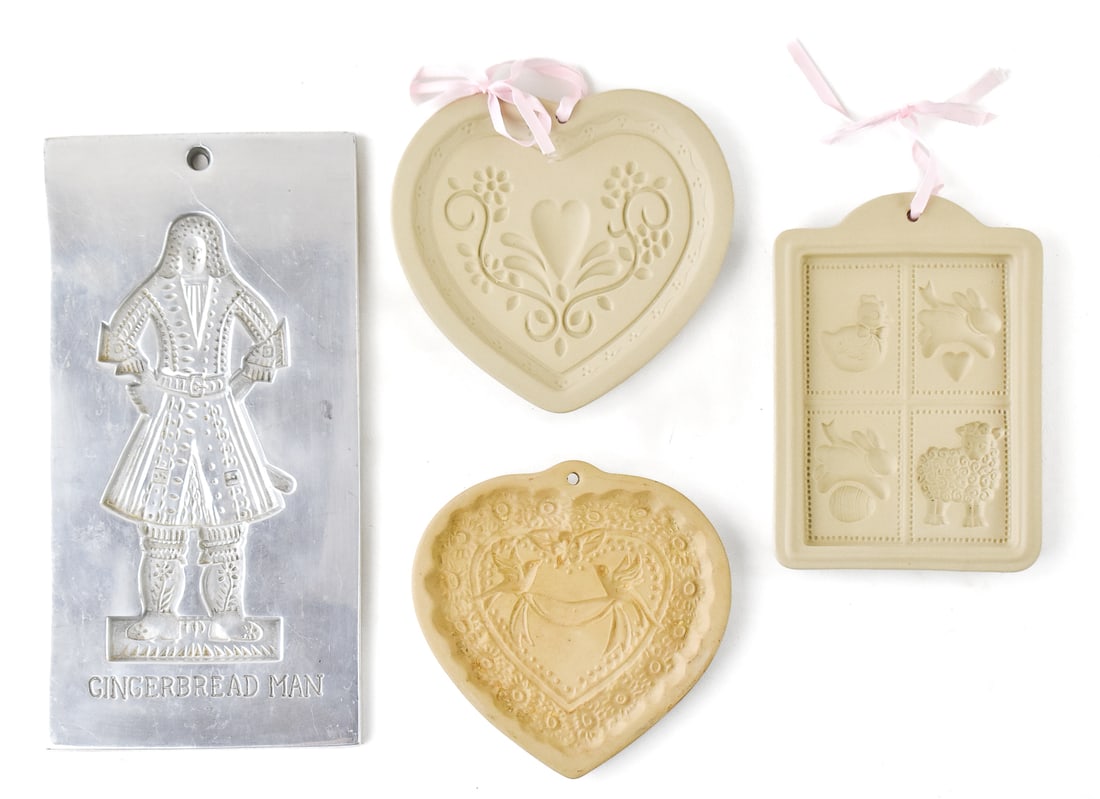 COOKIE MOLD ASSORTMENT: An assortment of cookie molds including three clay molds, and a cast aluminum mold copied from the bake shop in Williamsburg, Virginia. The aluminum mold measures 11.25" H x 6" W x 0.25" D.