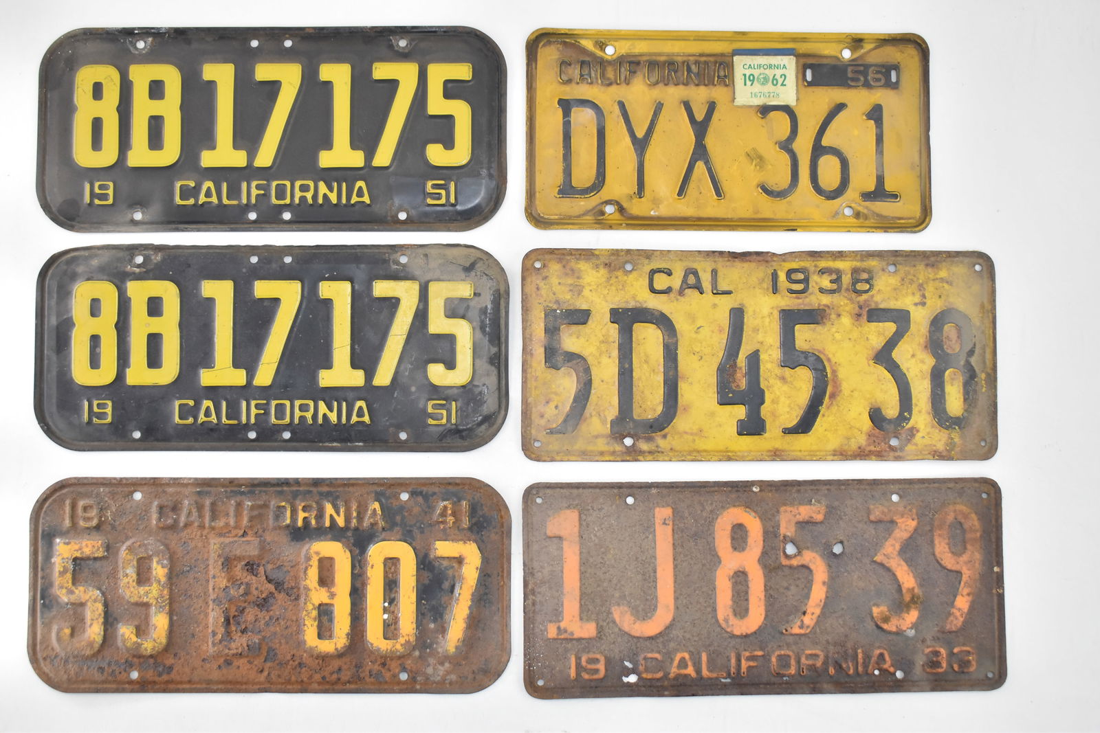 CALIFORNIA LICENSE PLATES: 1933, 1938, 1941, 1951, 1956, & 1962: This lot includes the following California license plates: 1933, 1938, 1941, two from 1951, and a 1956 plate with 1962 tags. The largest item measures 0.5" H, 14" W, 6.5" D.