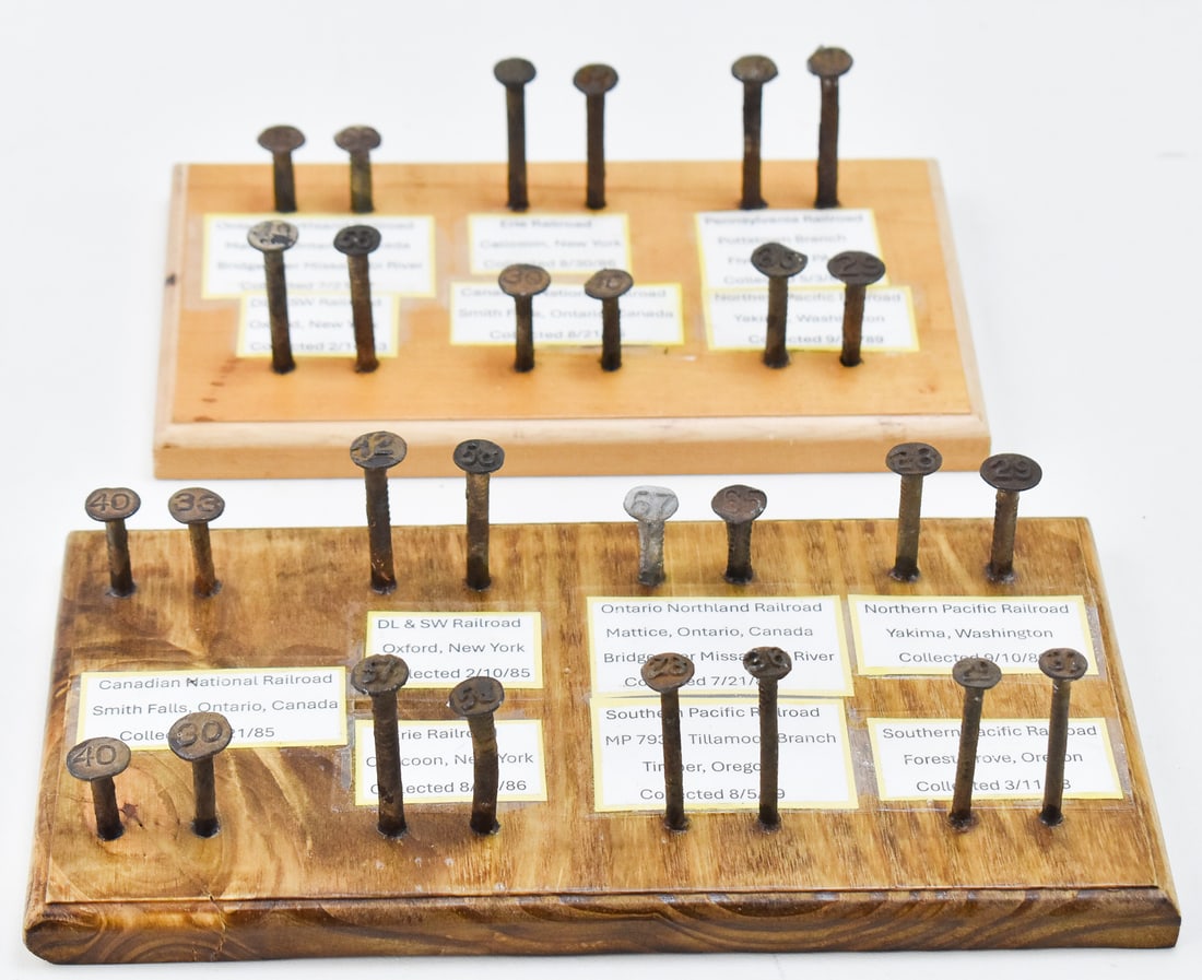 RAILROAD NAIL COLLECTION: Two wood displays with railroad nails collected from 14 different railroads across North America and were collected during the mid to late 1980's. The largest of the two displays measures 3.5" H x