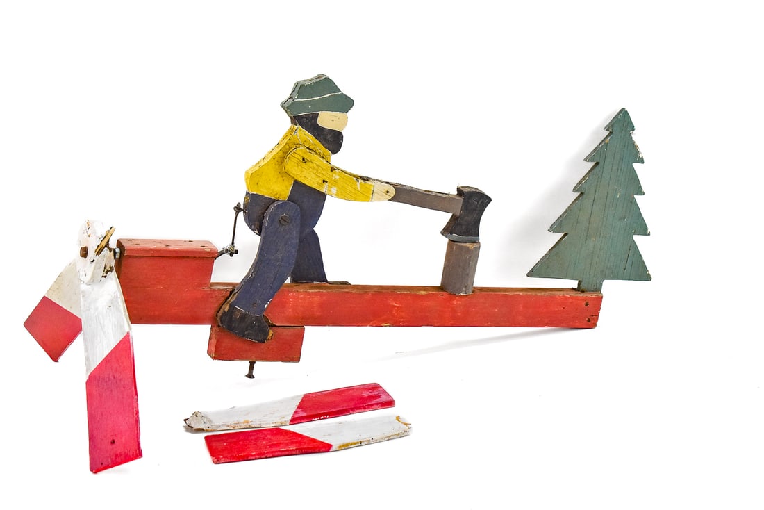 FOLK ART LUMBERJACK WHIRLIGIG: A vintage folk art lumberjack whirligig. When working the lumberjack will imitate chopping wood. The whirligig measures 12.5" H x 25" W x 13" D.