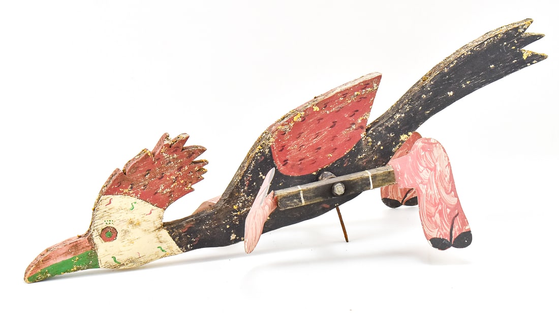 ROADRUNNER WHIRLIGIG. EARLY 20TH CENTURY: A wooden roadrunner whirligig, circa early 20th century. The whirligig measures 8" H x 25.5" W x 10" D.