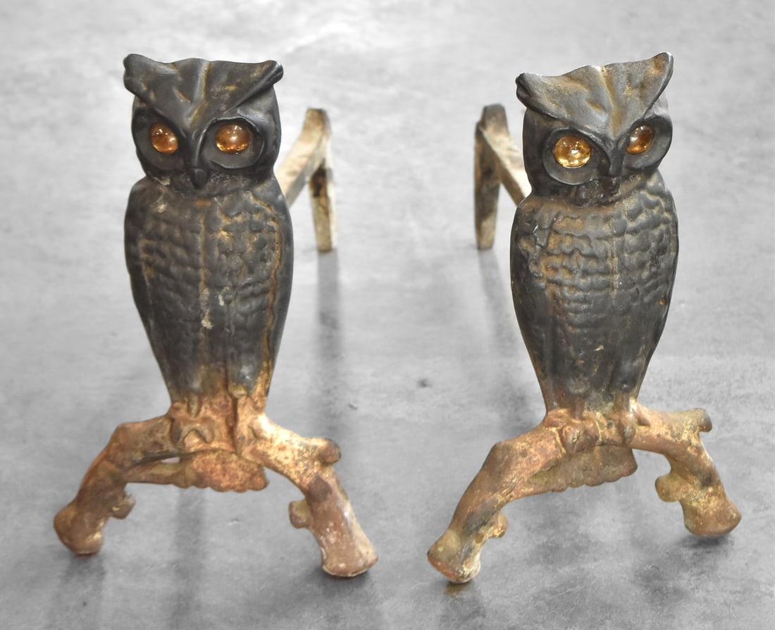 PAIR OF ANTIQUE CAST IRON OWL ANDIRONS WITH GLASS TOPAZ EYES: A pair of antique cast iron owl andirons with glass topaz eyes. They measure 13" H x 8" W x 18" D each.