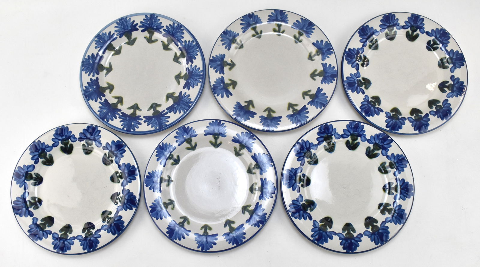 SIX LOUISVILLE STONEWARE PLATES: All plates are in the Louisville "Bachelor Button Blue" pattern. All pieces were manufactured in 1994. Each plate has a measurement of 11" H x 11" W x 1" D.