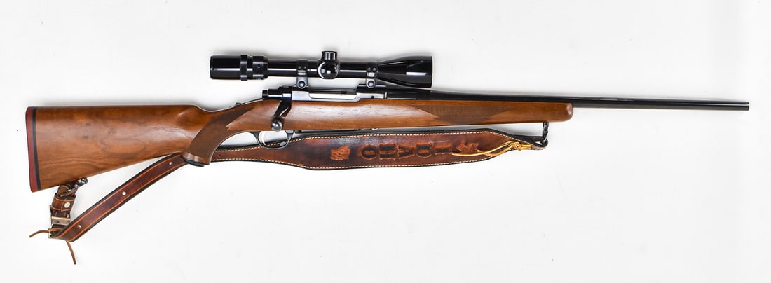 RUGER M77 .22-250 W/ BUSHNELL 3X-9X BANNER SCOPE: A Ruger M77 bolt-action rifle chambered in .22-250 with a Bushnell 3x-9x Banner scope and a leather sling with "Idaho" design. This rifle has a barrel length of 21.25" and a total measurement of 8" H