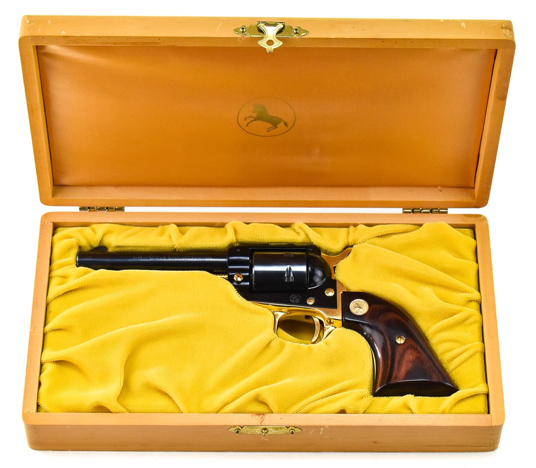 COLT ST. LOUIS BICENTENNIALCOMMEMORATIVE FRONTIER SCOUT SINGLE ACTION REVOLVER W/ CASE: A Colt St. Louis Bicentennial Commemorative Frontier Scout single action revolver chambered in .22 LR with a 4 3/4" round barrel. Manufactured in 1965. This revolver has a blued and gold finish with