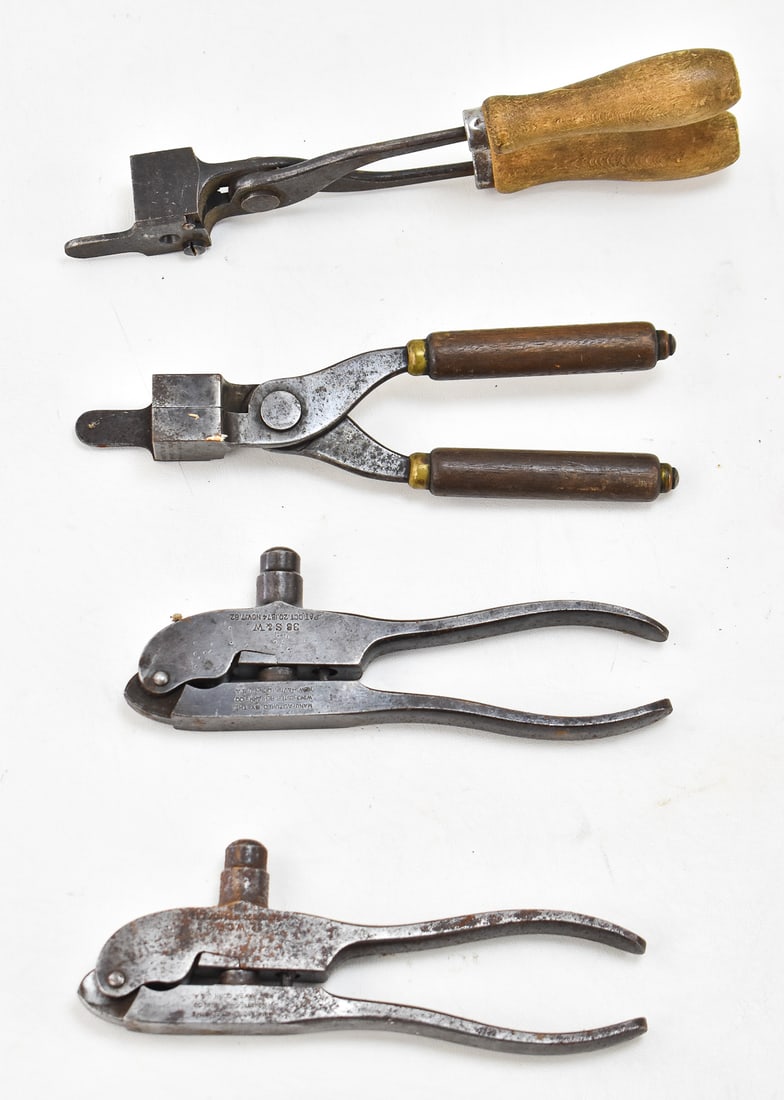 FOUR WINCHESTER REPEATING ARMS CO. BULLET MOLDS, LATE 19TH CENTURY: An assortment of four bullet molds made by the Winchester Repeating Arms Company: .32 WCF, .38 S&W, .32 WCF, and 40-60 WCF. For scale the largest bullet mold measures 9.5" H x 3" W x 1" D.