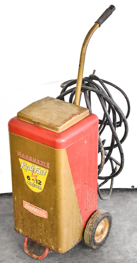 MARQUETTE REDI-FAST 6-12 ROLLING BATTERY CHARGER: The Marquette Redi- Fast Rolling Battery Charger is designed for charging automotive batteries of 6 volt and 12 volts. Unit including handle measures 34.5" H x 15" W x 18" D.