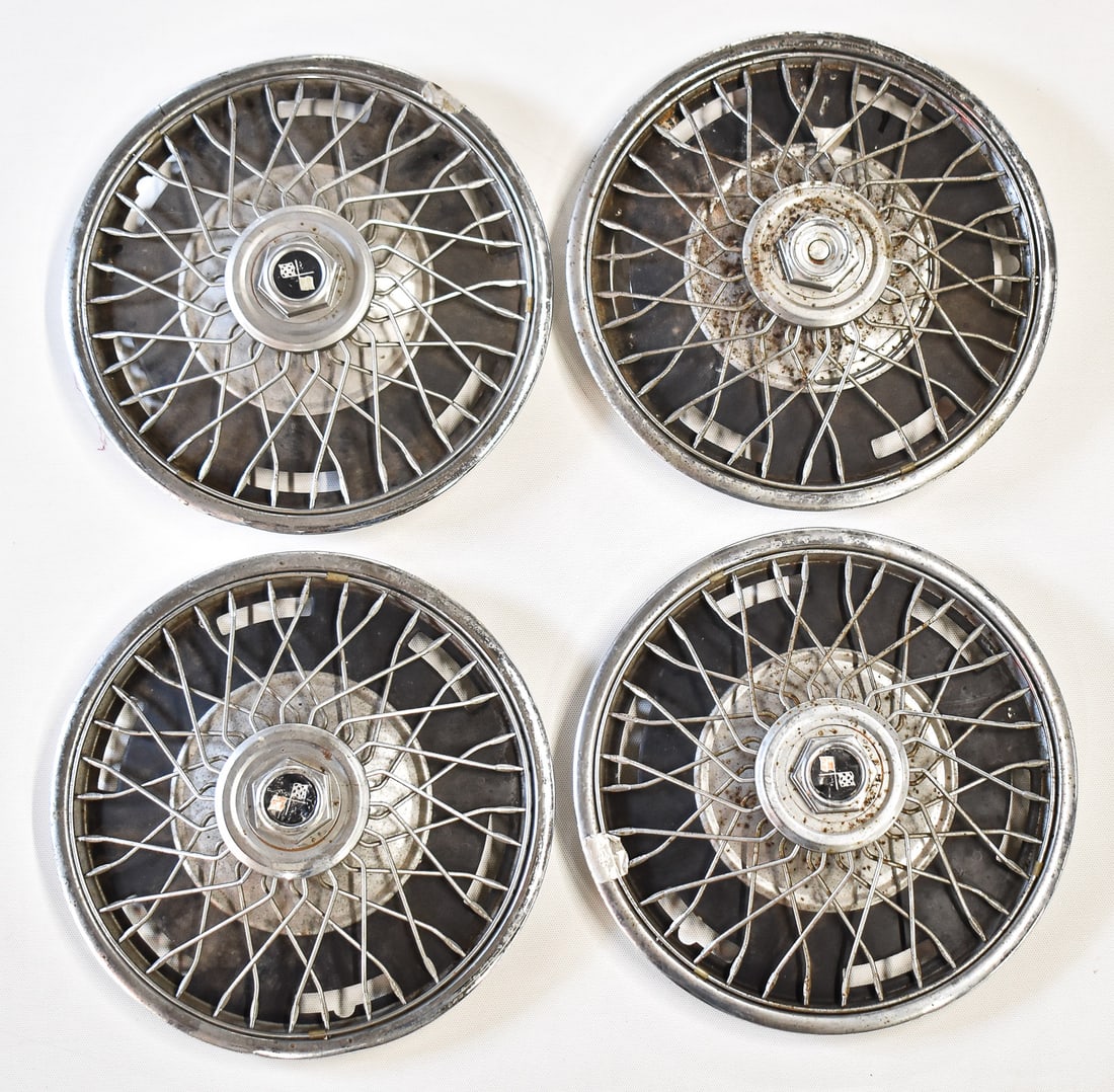 VINTAGE CHEVY CORVETTE SET OF 4, 16' WIRE SPOKED HUBCAPS: A set of four vintage wire spoked hubcaps for a Chevy Corvette. Each hubcap measures 16" H x 16" W x 4.5" D.