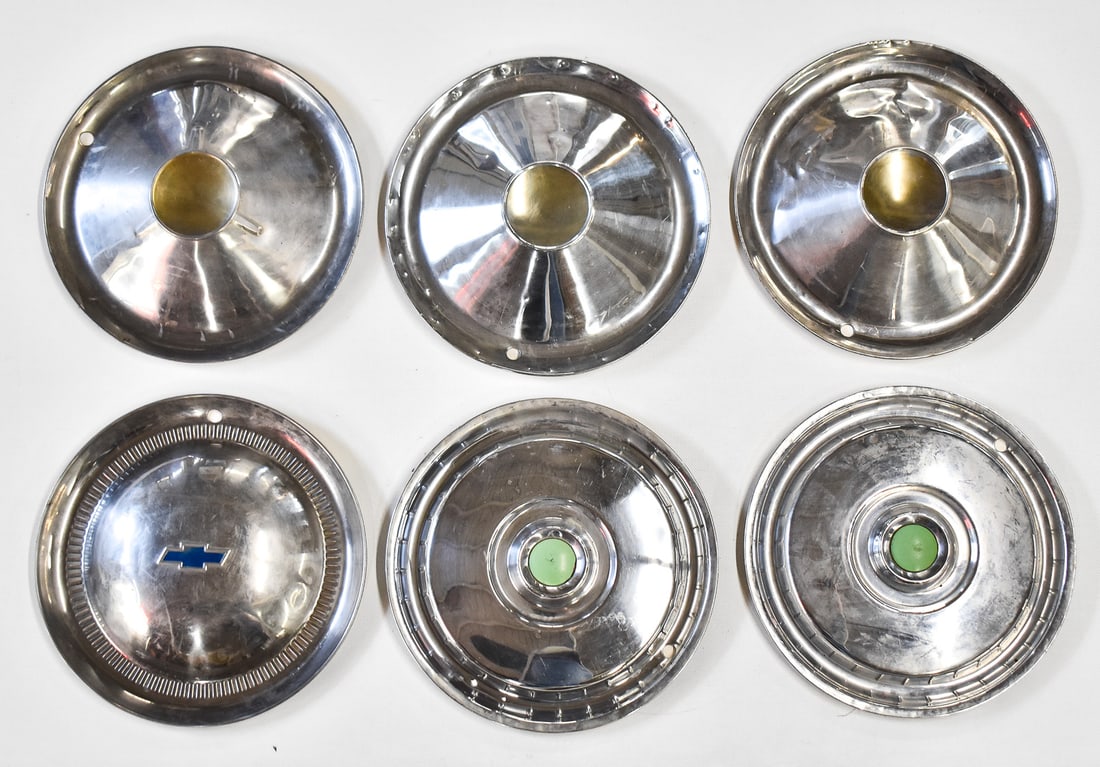 FORD, CHEVY, & MISCELLANEOUS HUBCAPS: An assortment of six vintage hubcaps including a Chevy hubcap, two Ford hubcaps with the center emblems painted light green, and three conical style unbranded hubcaps. The conical hubcaps measure 15"