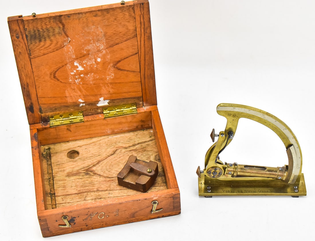 JAPANESE BRASS RADIUS GUNNER'S LEVEL QUADRANT: YOKOSUKA NAVAL BASE: A brass radius gunner's level quadrant with a wooden transport case for Yokosuka Naval Base and marked "Harold Doumeng", circa early 20th century. The item measures 2.5" H, 8.5" W, 8" D.