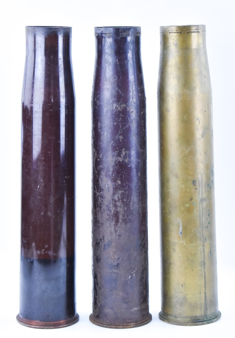 THREE 90MM SHELLS: A set of three 90mm shells including one that is unmarked, one marked M71A1 and the last is an M71 Flashless shell, circa 1954. Each shell measures 24" H x 5" W x 5" D.