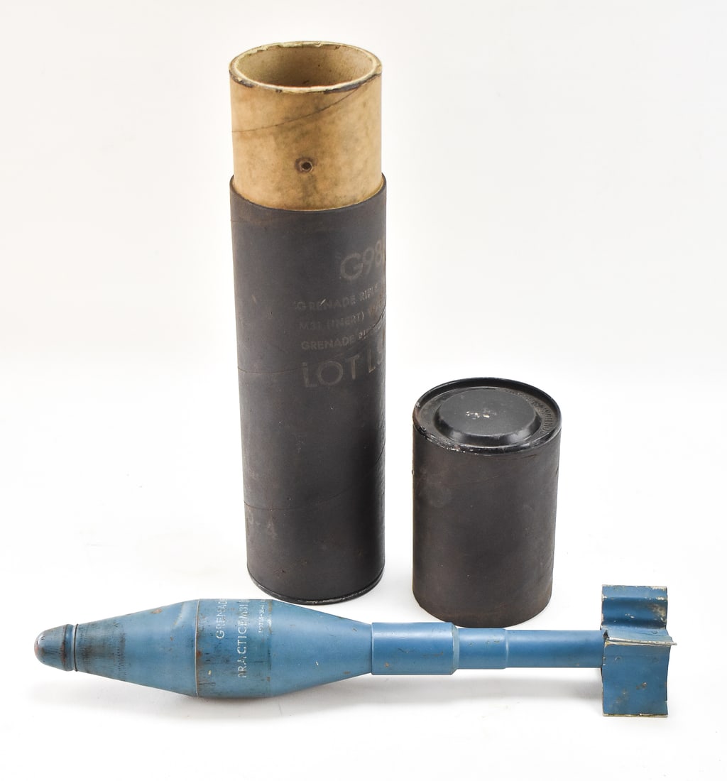M31 GRENADE RIFLE INERT PRACTICE ROUND W/ TUBE: An M31 Grenade Rifle inert practice round complete with the original storage tube, circa 1963. The tube measures 18" H x 4" W x 4" D.